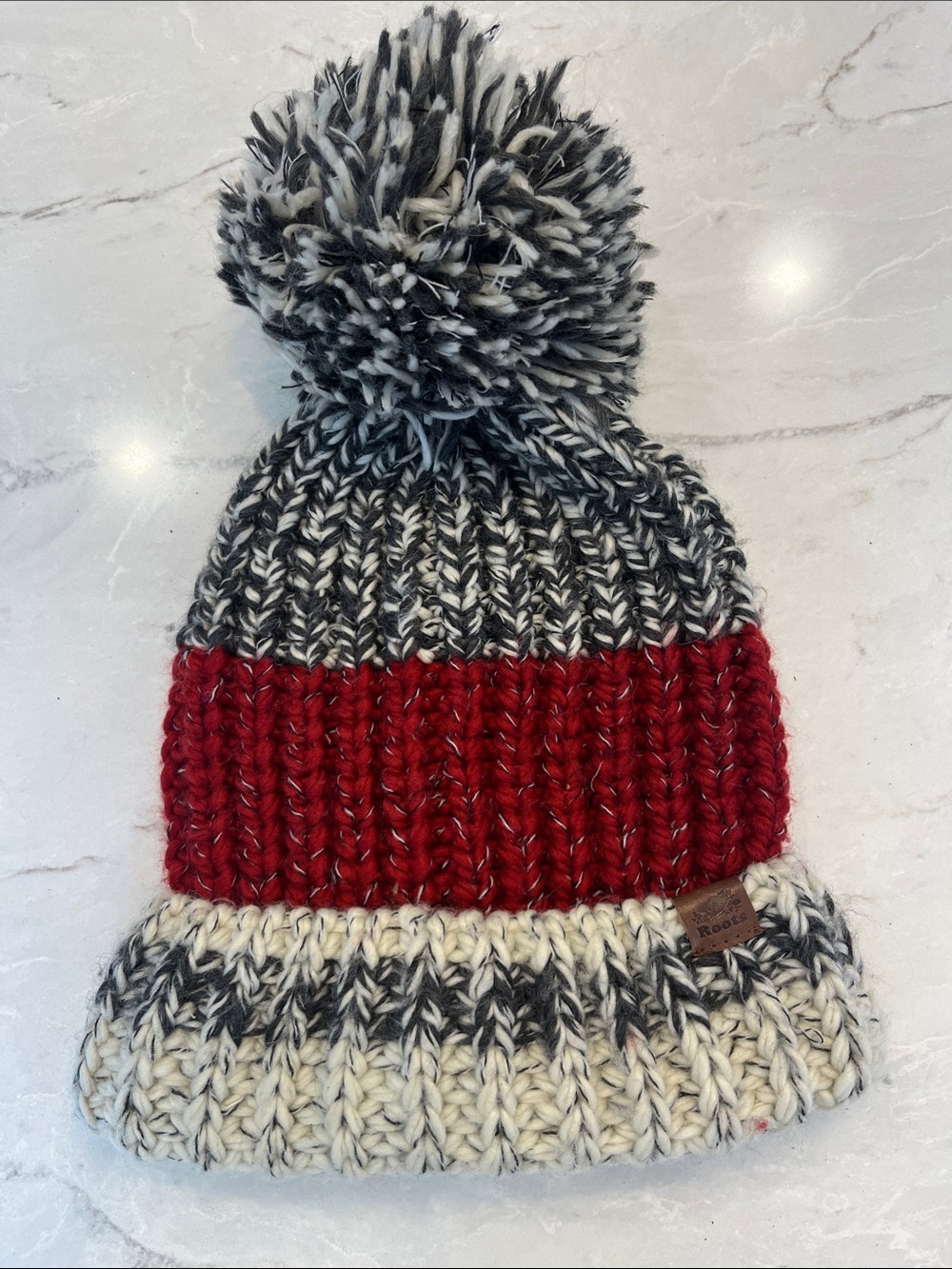 Roots Marled Black & Cream Pom Pom Beanie with Red Band